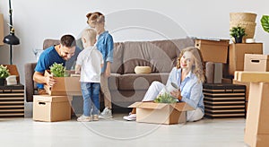 Happy family mother father and children move to new apartment an