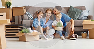 Happy family mother father and children move to new apartment an