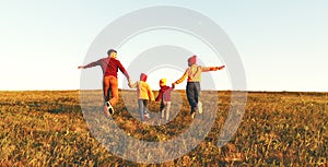 Happy family: mother, father, children son and daughter on autumn sunset