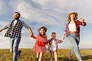 Happy family: mother, father, children son and daughter on nature  on sunset