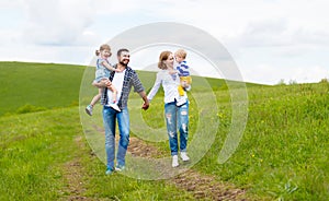 Happy family: mother, father, children son and daughter on summer photo