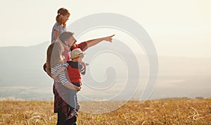 Happy family: mother, father, children son and daughter on sunset