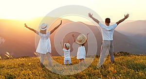 Happy family: mother, father, children son and daughter on sunset