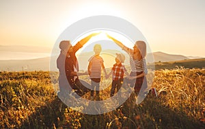 Happy family: mother, father, children son and daughter on sunset