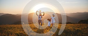 Happy family: mother, father, children son and daughter on sunset