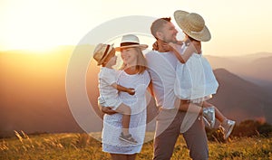 Happy family: mother, father, children son and daughter on sunset