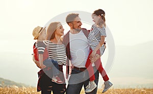 Happy family: mother, father, children son and daughter on sunset