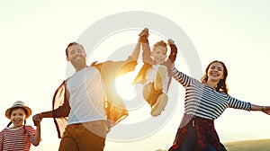 Happy family: mother, father, children son and daughter on sunset