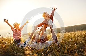 Happy family: mother, father, children son and daughter on sunset