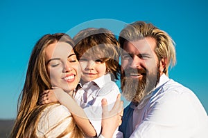 Happy family, mother, father and children son embrace. Young smiling family with one child having fun together. Kids