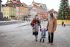 Happy Family - mother, father and little girl walking in autumn city and having fun