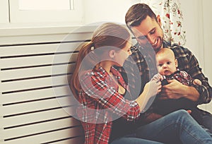 Happy family mother and father playing with a baby