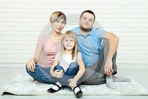 Happy family mother and father playing with baby at home