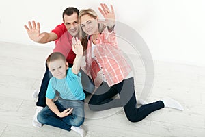 Happy family mother and father playing with baby at home