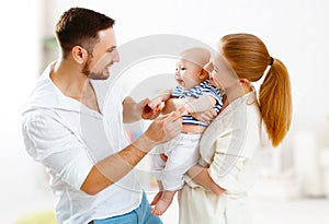 Happy family mother, father and son, baby at home