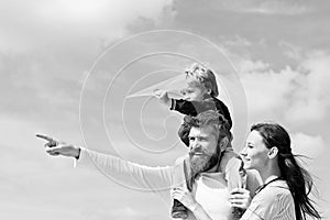 Happy family - mother, father and son on sky background in summer. Dream of flying. Happy family father and child on