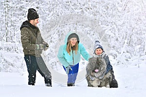Happy family: mother, father, son and their big dog