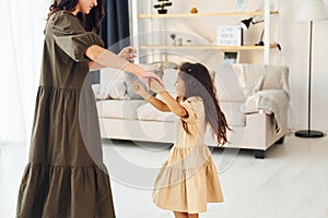 Happy family. Mother and her daughter spending time together at home