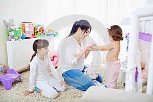 Happy family. Mother and her daughters children girls hugging.