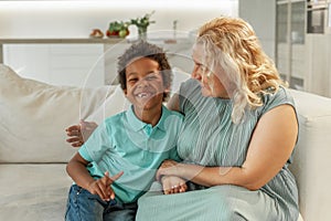 Happy family mother and her son having fun and laughing at home