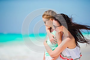 Happy family of mother and little girl at tropical beach