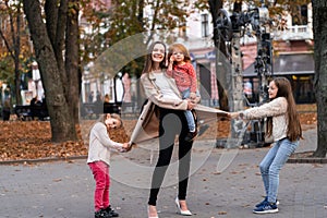 Happy family. mother of many children and three daughters child girl together, hugging, joyfully laughing and posing