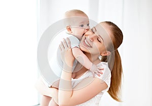 Happy family mother playing with baby