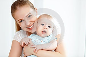 Happy family mother playing with baby