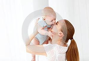 Happy family mother playing with baby