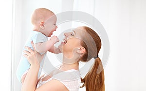 Happy family mother playing with baby