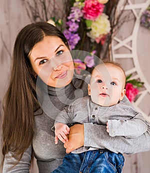 Happy family. mother playing with her baby in the room.