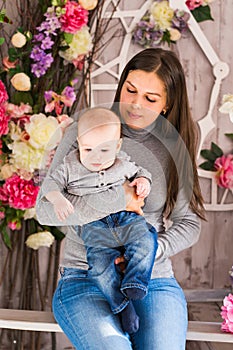 Happy family. mother playing with her baby in the room.