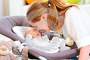 Happy family. mother plays with newborn baby