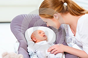 Happy family. mother plays with newborn baby