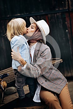 Happy family. Mother with son child playing having fun together on the grass in sunny summer day. Life moment