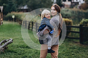 Happy family. Mother with son child playing having fun together on the grass in sunny summer day. Life moment