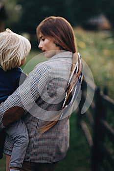 Happy family. Mother with son child playing having fun together on the grass in sunny summer day. Life moment