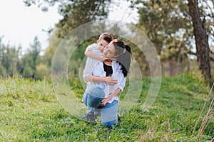 Happy family! Mother with son child playing having fun together on the grass in sunny summer day, life moment