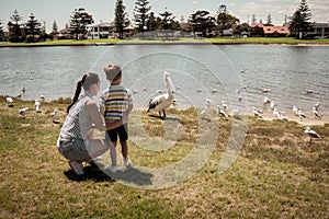 Happy family. Mother and son having fun in the park by the lake