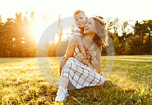 Happy family: mother and son hugging in nature in summer