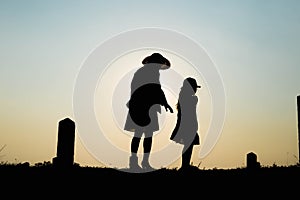 Happy family. A mother and son playing in grass fields outdoors at evening silhouette.Vintage Tone and copy space