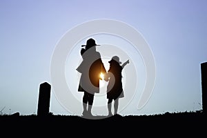 Happy family. A mother and son playing in grass fields outdoors at evening silhouette.Vintage Tone and copy space