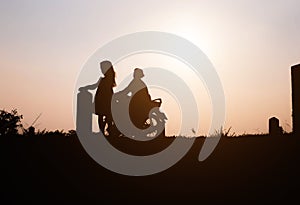 Happy family. A mother and son playing in grass fields outdoors at evening silhouette.Vintage Tone and copy space