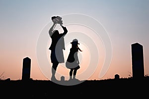 Happy family. A mother and son playing in grass fields outdoors at evening silhouette.Vintage Tone and copy space