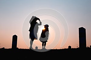Happy family. A mother and son playing in grass fields outdoors at evening silhouette.Vintage Tone and copy space