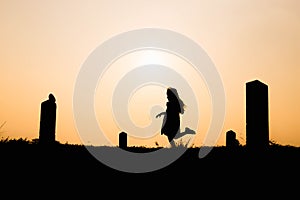 Happy family. A mother and son playing in grass fields outdoors at evening silhouette.Vintage Tone and copy space