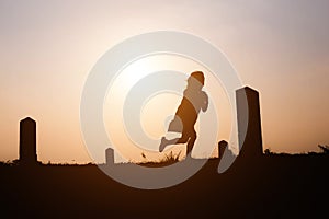 Happy family. A mother and son playing in grass fields outdoors at evening silhouette.Vintage Tone and copy space