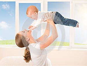 Happy family. Mother throws up baby, playing