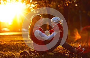 Happy family mother and toddler outdoors in park