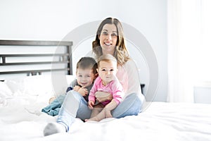 Happy family mother and two children, son and daughter in bed